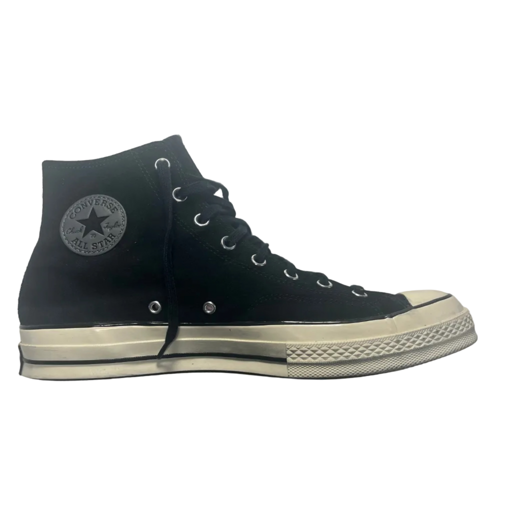 Black high-top sneaker with white sole on a gray background