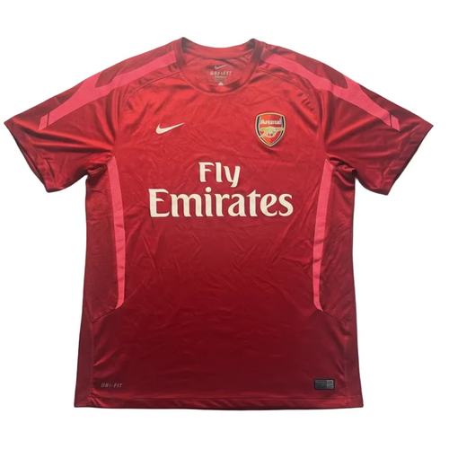 Red sports jersey with Emirates logo on a white background