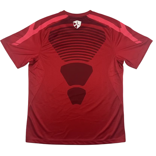 Red t-shirt with black design on a white surface