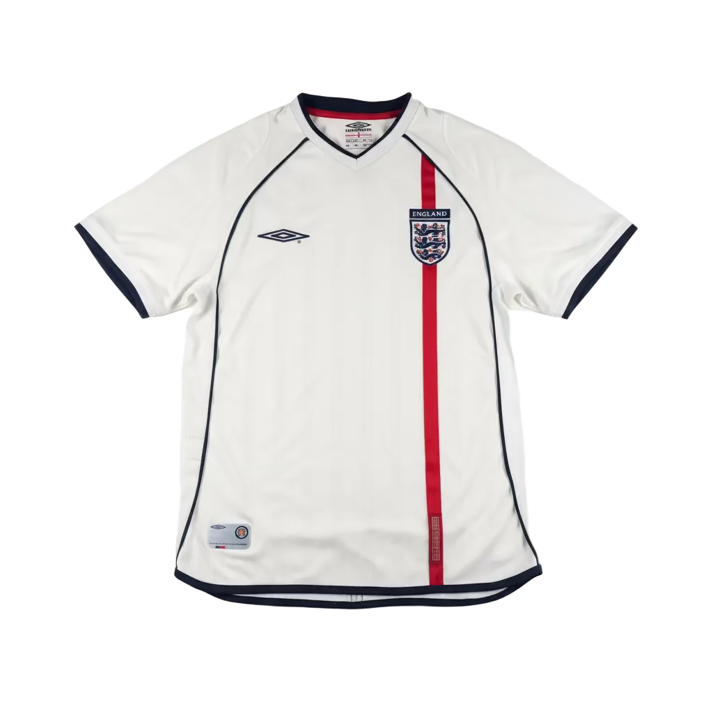 White sports jersey with red stripe and Umbro logo on a white surface