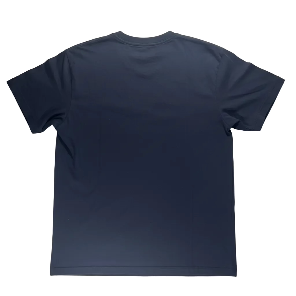 Black t-shirt on a white surface with a remote control in the foreground.