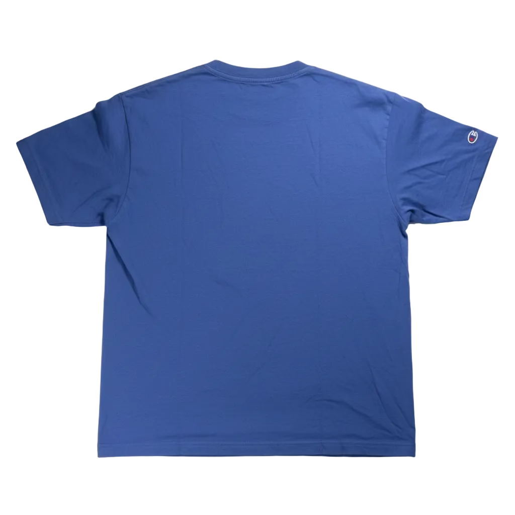 Blue t-shirt on a white surface with a visible brand logo.