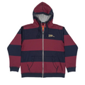 Red and navy striped hoodie on a white surface with electronic equipment in the background