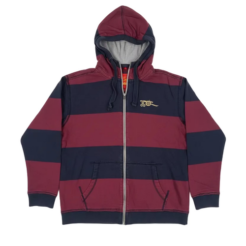 Red and navy striped hoodie on a white surface with electronic equipment in the background